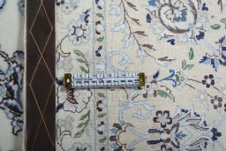 Backside of handmade New Nain rug showing knot structure and weave density