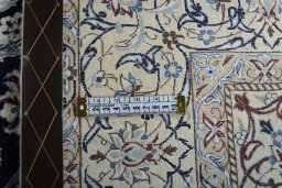 Backside of handmade New Nain rug showing knot structure and weave density
