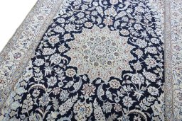 Backside of handmade New Nain rug showing knot structure and weave density