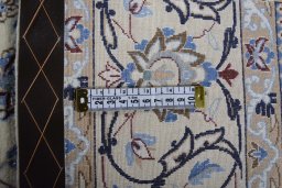 Backside of handmade New Nain rug showing knot structure and weave density