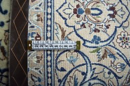 Backside of handmade New Nain rug showing knot structure and weave density