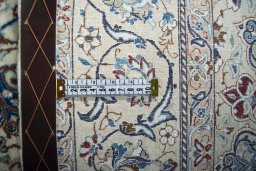 Backside of handmade New Nain rug showing knot structure and weave density