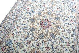 Backside of handmade New Nain rug showing knot structure and weave density