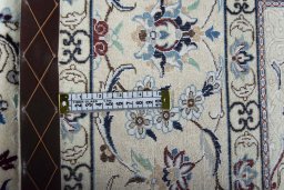 Backside of handmade New Nain rug showing knot structure and weave density