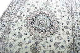Backside of handmade New Nain rug showing knot structure and weave density