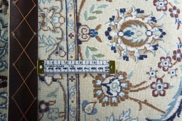 Backside of handmade New Nain rug showing knot structure and weave density