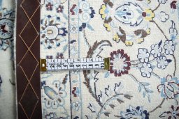 Backside of handmade New Nain rug showing knot structure and weave density