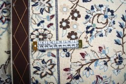 Backside of handmade New Nain rug showing knot structure and weave density