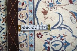 Backside of handmade New Nain rug showing knot structure and weave density