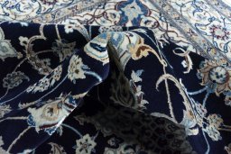 Backside of handmade New Nain rug showing knot structure and weave density