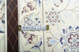 Backside of handmade New Nain rug showing knot structure and weave density