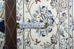 Backside of handmade New Nain rug showing knot structure and weave density