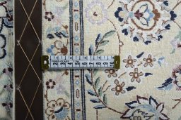 Backside of handmade New Nain rug showing knot structure and weave density