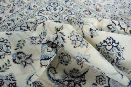 Backside of handmade New Nain rug showing knot structure and weave density