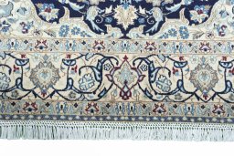 Corner detail of 2000s Nain rug showing border pattern and Wool pile