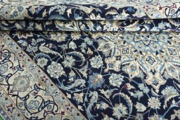 Surface texture of 2000s Nain rug with natural Wool and intricate pattern