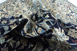 Backside of handmade 2000s Nain rug showing knot structure and weave density