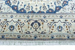 Corner detail of 2000s Nain rug showing border pattern and Wool pile