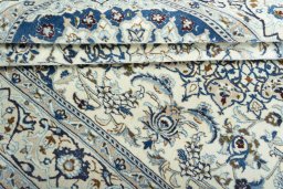 Surface texture of 2000s Nain rug with natural Wool and intricate pattern