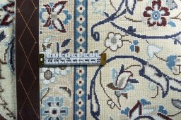 Backside of handmade 2000s Nain rug showing knot structure and weave density