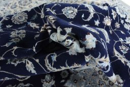 Backside of handmade New Nain rug showing knot structure and weave density