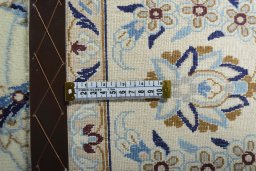Backside of handmade New Nain rug showing knot structure and weave density