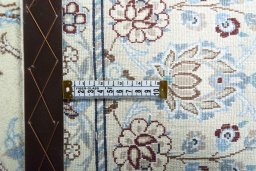 Backside of handmade New Nain rug showing knot structure and weave density