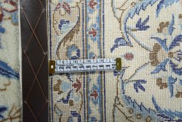 Backside of handmade New Nain rug showing knot structure and weave density