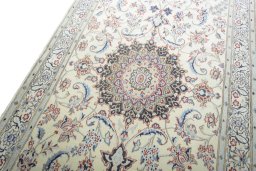 Backside of handmade New Nain rug showing knot structure and weave density