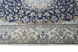 Corner detail of 2000s Nain rug showing border pattern and Cork pile