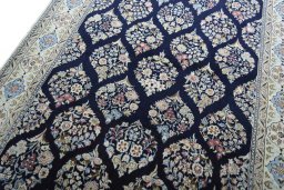 Backside of handmade New Nain rug showing knot structure and weave density