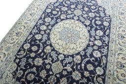 Backside of handmade New Nain rug showing knot structure and weave density
