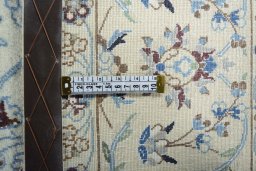 Backside of handmade New Nain rug showing knot structure and weave density