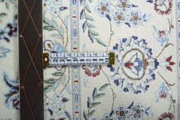 Backside of handmade New Nain rug showing knot structure and weave density