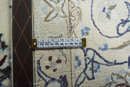 Backside of handmade New Nain rug showing knot structure and weave density