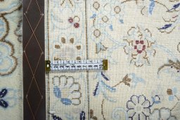 Backside of handmade New Nain rug showing knot structure and weave density