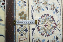 Backside of handmade New Nain rug showing knot structure and weave density