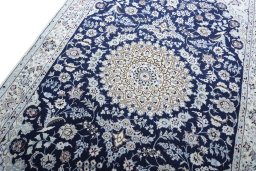 Backside of handmade New Nain rug showing knot structure and weave density
