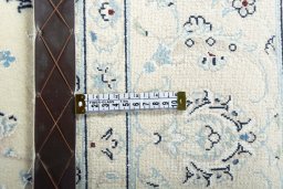 Backside of handmade New Nain rug showing knot structure and weave density