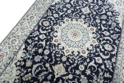 Backside of handmade New Nain rug showing knot structure and weave density