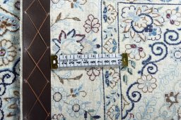 Backside of handmade New Nain rug showing knot structure and weave density