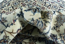 Backside of handmade New Nain rug showing knot structure and weave density