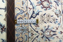 Backside of handmade New Nain rug showing knot structure and weave density