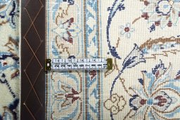 Backside of handmade New Nain rug showing knot structure and weave density