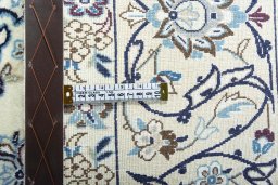 Backside of handmade New Nain rug showing knot structure and weave density
