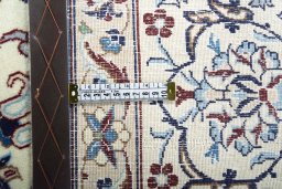 Backside of handmade New Nain rug showing knot structure and weave density