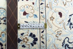 Backside of handmade New Nain rug showing knot structure and weave density