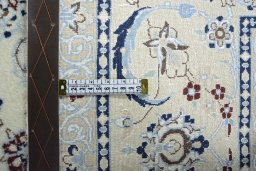 Backside of handmade New Nain rug showing knot structure and weave density