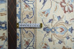 Backside of handmade New Nain rug showing knot structure and weave density