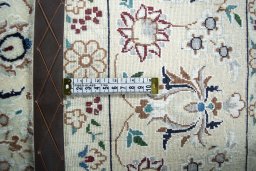 Backside of handmade New Nain rug showing knot structure and weave density
